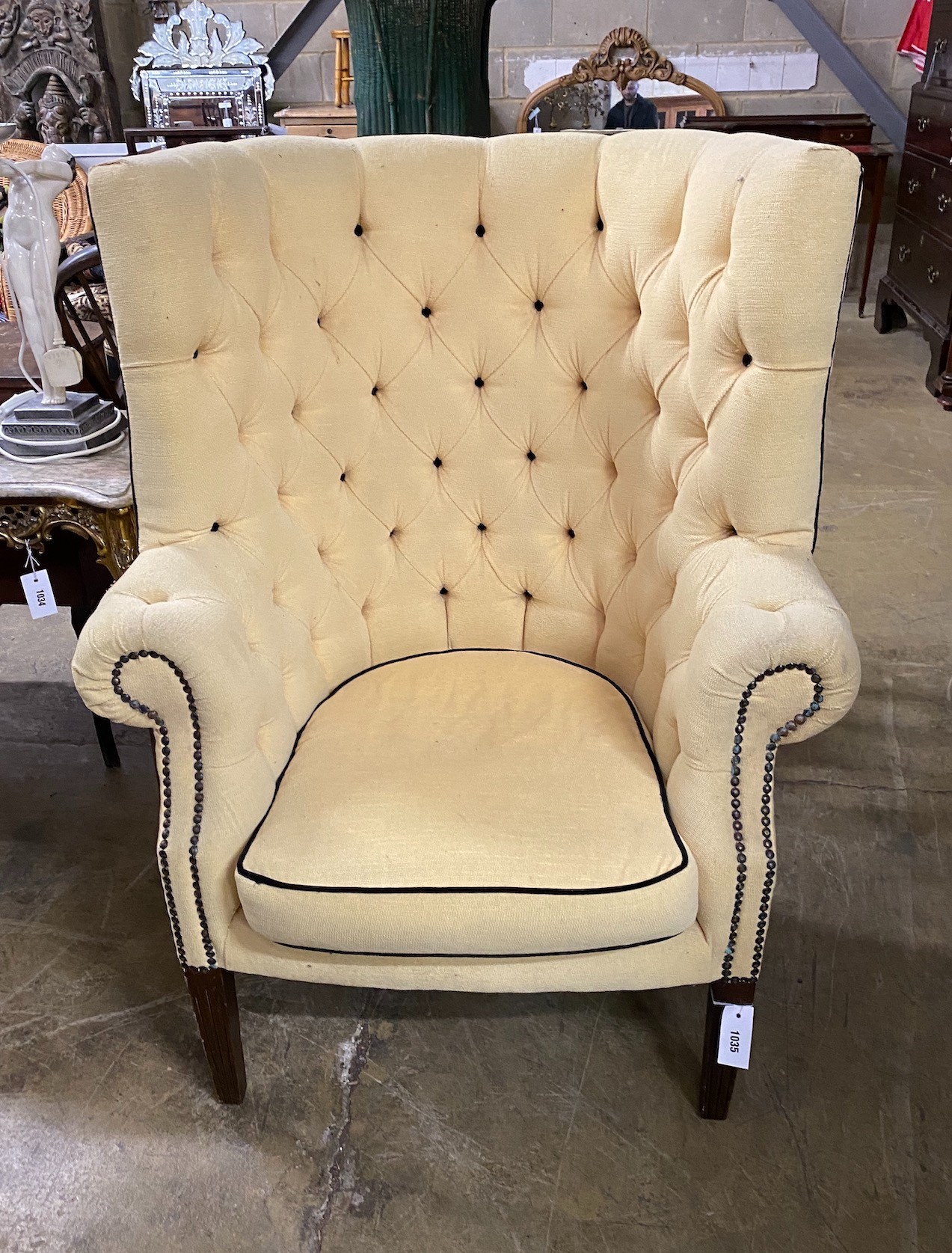 A Georgian style button back wing armchair, width 80cm, height 114cm